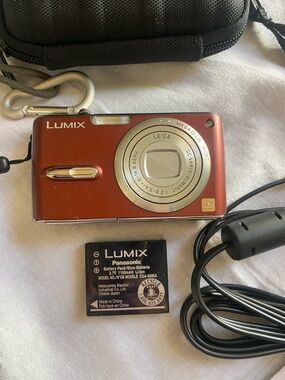 Panasonic Lumix Red Compact Digital Camera with accessories and camera case